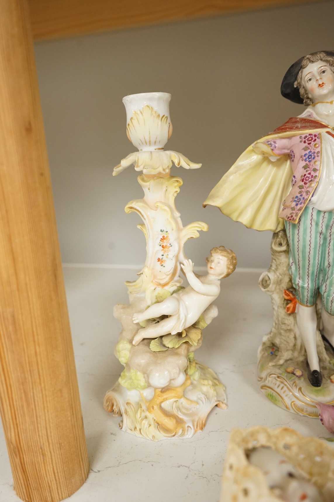 A pair of Sitzendorf figurines, damage to one, a pair of candlesticks, a Rye pottery dish, a Moore Bros. wall pocket, a doll and a basket, tallest 22.5cm